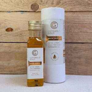 Bottle of Cotswold Gold white truffle extra virgin cold-pressed rapeseed oil beside its packaging tube